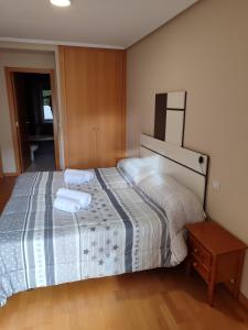 a bedroom with a bed with two towels on it at Verarlanza in Lerma