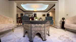 a reception desk in a lobby with two chairs at Turquoise Pyramids Palace in Giza