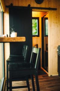 a black chair and a table in a room at Včelín Müslivna in Jablonné v Podještědí +9 photos