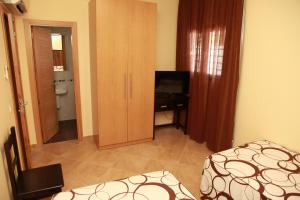 a bedroom with a bed and a desk and a mirror at Hostal Doña Manuela in Málaga