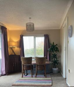 a dining room table with two chairs and a window at 2 Bedroomed Lodge with Private Garden in Penrith