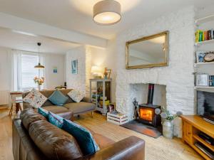 a living room with a couch and a fireplace at 3 Bed in Brixham 64703 in Brixham