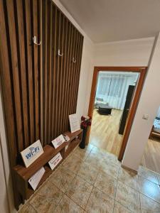 a living room with a wooden wall at Apartman Basic Doboj in Doboj +6 photos