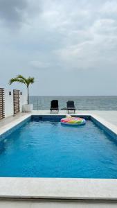 a swimming pool with a frisbee in the water at Seascape Villa in Fujairah