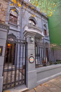 a blue building with a gate in front of it at Play Hostel Arcos in Buenos Aires