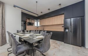 a dining room with a table and a refrigerator at Cdi706 in Murvica