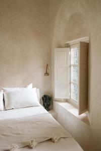 מיטה או מיטות בחדר ב-Riad Le Sable Vert