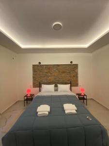 a bedroom with a large bed with two chairs at Alexandra apartment in Athens