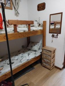 a bedroom with two bunk beds and a mirror at Le rêve de Lou et balou in Saint-Gervais-les-Bains