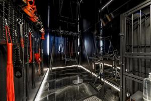 a stairway in a room with orange ropes at World Of Ecstasy - Apartament BDSM in Reda