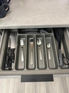 bandeja con utensilios en el fregadero de la cocina en Mood Apartment 4 en Bedlington