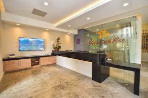 a lobby with a reception desk and a sign on the wall at Los Suenos Resort Casa Puesta del Sol by Stay in CR in Herradura