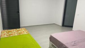 an empty room with a bed and a door at Palmira House in Cidade Velha