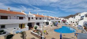 an aerial view of a resort with a swimming pool at Wonderful seaview apartment - Los Cristianos in Arona