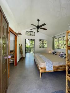 a bedroom with a bed and a ceiling fan at Jungle Passion Lodge in Ojochal