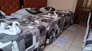 Postel nebo postele na pokoji v ubytování Hotel Kamelot Parque Central