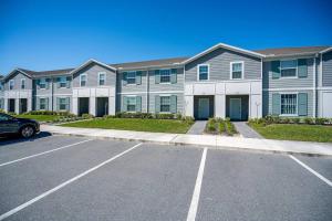 a row of apartment buildings with a parking lot at Luxury Living at its Finest in Davenport, FL in Davenport