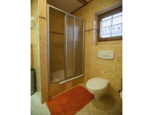 a bathroom with a toilet and a shower and a window at Four -anniversary Type C in Dźwirzyno