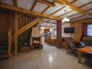 a living room with a fireplace and a dining room at Four -anniversary Type C in Dźwirzyno