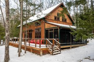a log cabin in the woods in the snow at Lake Winnipesaukee - Waterfront - 312 in Meredith
