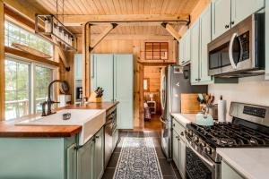 a kitchen with a sink and a stove at Lake Winnipesaukee - Waterfront - 312 in Meredith