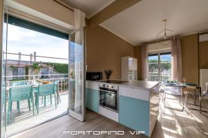 a kitchen with a view of a balcony at Casa Gelsomini by PortofinoVip in Santa Margherita Ligure