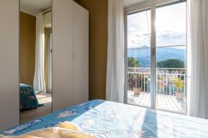 a bedroom with a bed and a large window at Casa Gelsomini by PortofinoVip in Santa Margherita Ligure