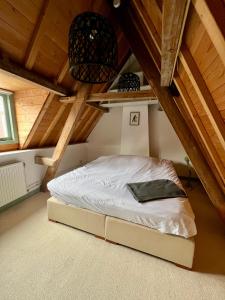 a bed in the attic of a room at Appartement centrum Delft in Delft