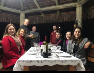 a group of people sitting around a table with wine glasses at Sítio Paz e Sossego in Têsto Salto +19 photos
