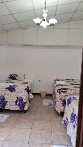 Postel nebo postele na pokoji v ubytování Hotel Kamelot Parque Central