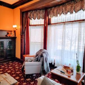a living room with a couch and a window at The Kings Throne Inn and Guest House in Toledo