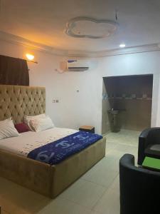 a bedroom with a large bed and a bathroom at Nobles Hotel & Suites in Lagos