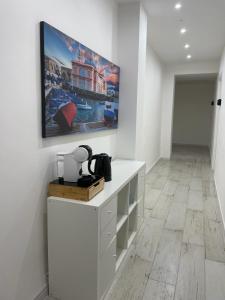 a white room with a tv on a wall at Maison appartaments in Bari