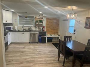 a kitchen and dining room with a table and a table and a dining room at Small lakefront cabin in Sylvan Lake