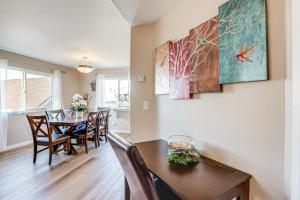 a dining room and living room with a table and chairs at Pismo Beach Condo with Balcony Near Wineries! in Pismo Beach