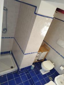 a bathroom with a toilet and a sink and a tub at Casa Mamma Mia in Albori