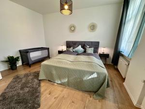 a bedroom with a bed and a flat screen tv at Retreat am Teich in Altenburg