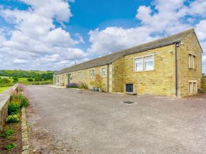 a large brick building with a gravel driveway at 3 Bed in Denby Dale 88924 in Denby Dale