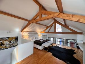 ポルトにあるOporto Golden Apartmentの屋根裏のベッドルーム(大型ベッド1台、木製の梁付)