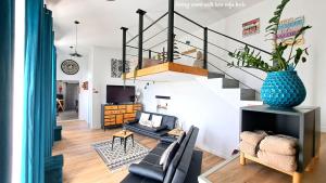 a living room with a staircase and a couch at Espirito do Mar - Premium Villa with Jacuzzi in Estreito da Calheta