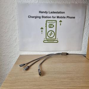 a wooden table with a charging station for mobile phone at Exklusives Apartment nah S-Bahn in Bochum