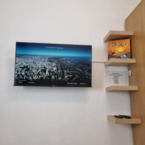 a flat screen tv hanging on a wall at Exklusives Apartment nah S-Bahn in Bochum