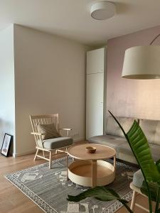Una sala de estar con un sofá, una mesa y una silla. en DearDeer Apartment, en Liptovský Mikuláš