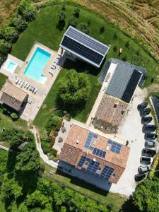an overhead view of solar panels on a house with a pool at Amico Country House in Serra San Quirico