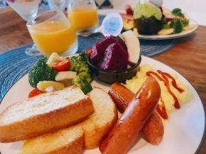 a plate of breakfast food with toast bread and vegetables at QBE B&B in Nanwan