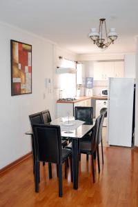 a dining room table and chairs in a kitchen at Departamentos Amoblados La Hermandad in Antofagasta