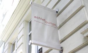 a white umbrella hanging from a building at Schlaflounge in Hamburg