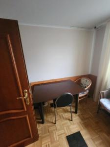 a small room with a table and a chair at Pension Doppelzimmer mit Balkon 24 