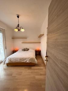 a bedroom with a bed and two night stands with lights at Casa Vacanza Latte in Latte