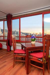 a dining room with a table and chairs with a view at SUNSHINE Apartament in Benidorm